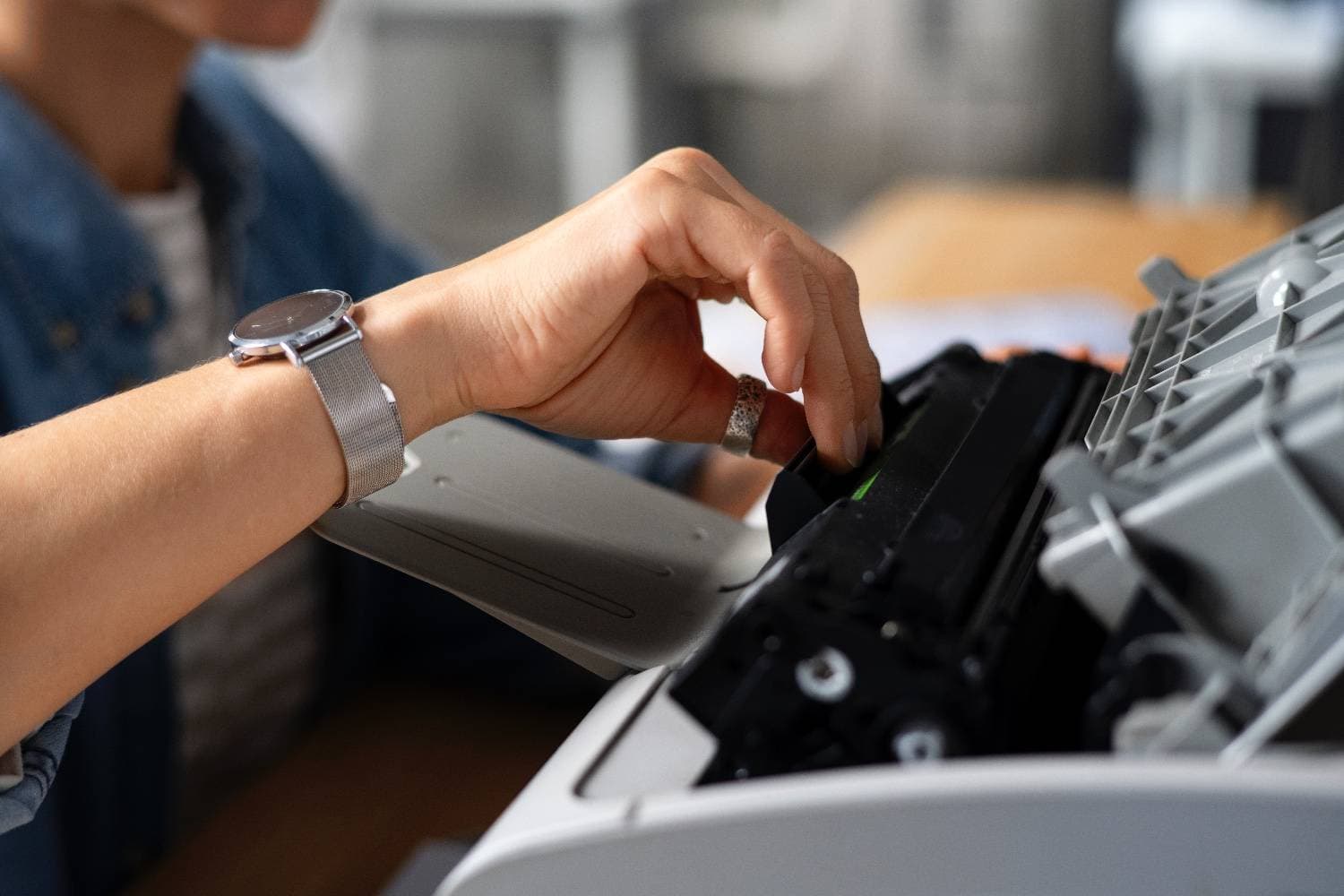 Professional using modern printer in office environment